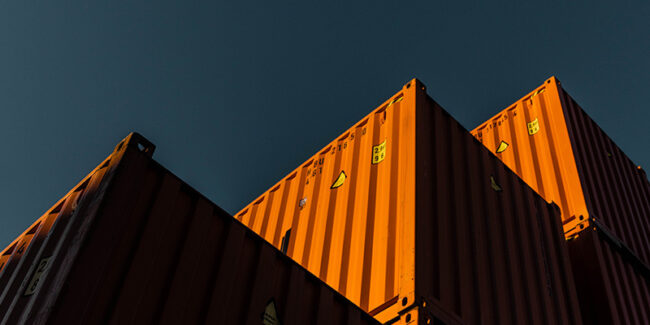 Metal shipping containers stacked in storage