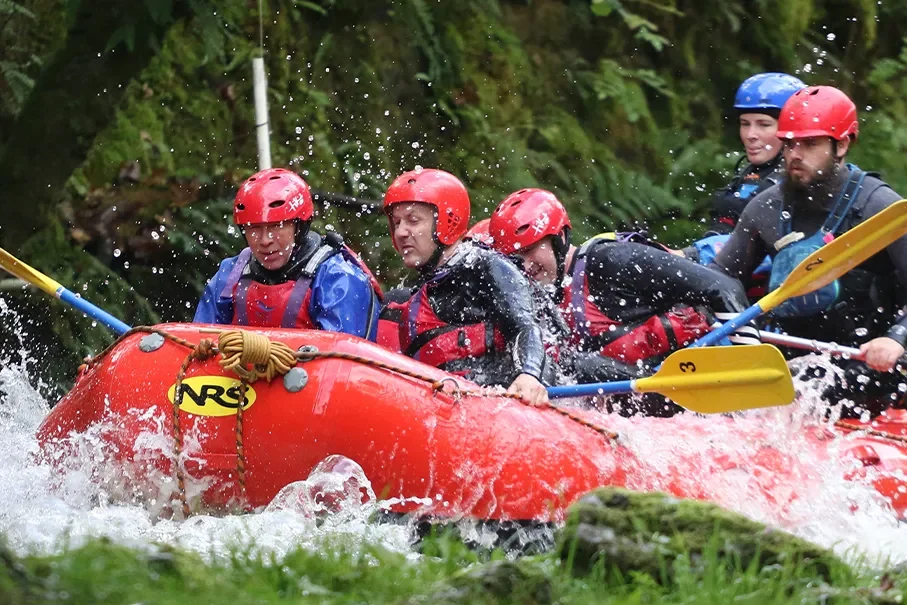 Group white water rafting in North Wales