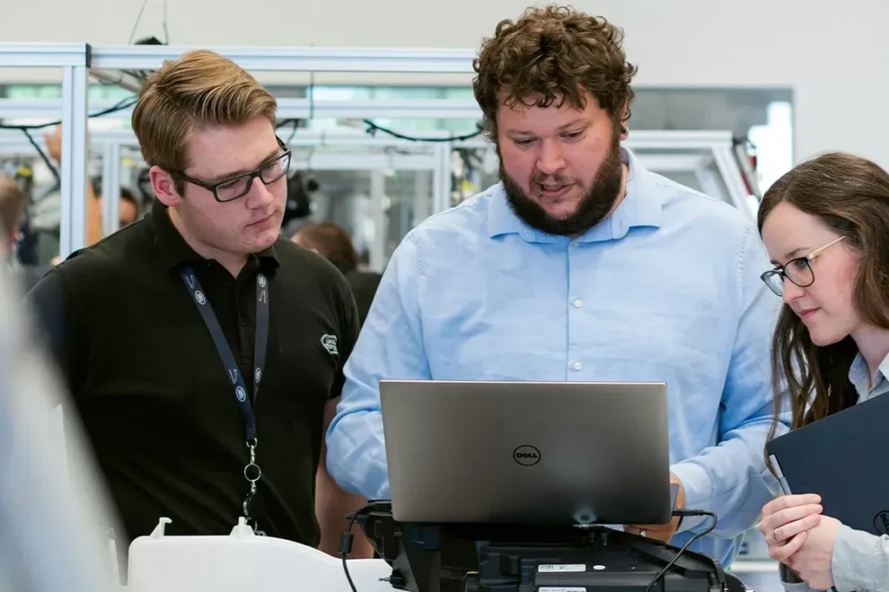 Three engineers collaborating on a technical project